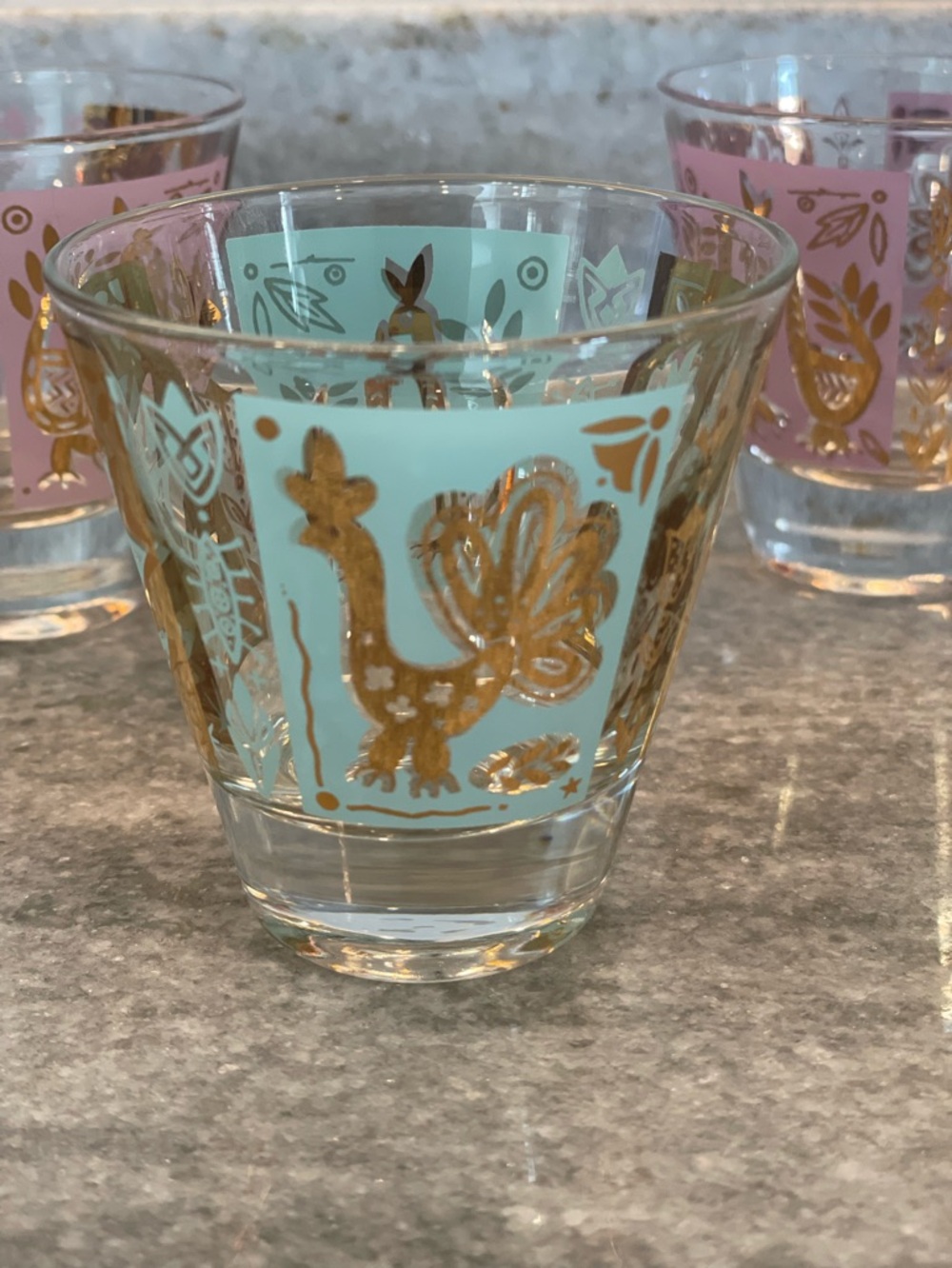 Vintage MCM shot glasses . Set of 3 .1 Aqua and 2 Lavender with gold peacock’s.